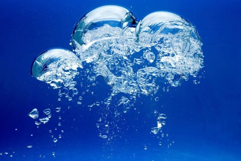Bright Air bubbles, blue background in an aquarium