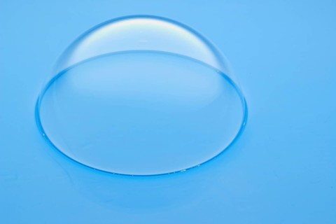 A large soap bubble on light blue water