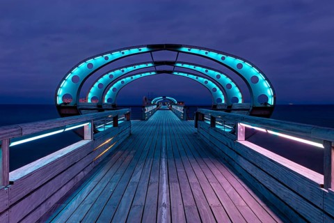 Long exposure during the blue hour of the pier of Kellenhusen at the Baltic Sea with blue