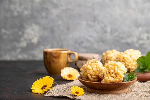 Traditional Tatar candy chak-chak made of dough and honey with cup of coffee on a black concrete