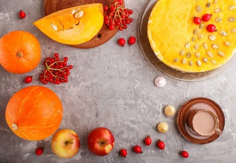 Traditional american sweet pumpkin pie decorated with hawthorn red berries and pumpkin seeds with