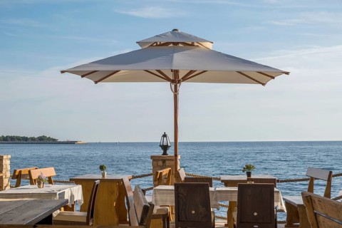 Tables in a restaurant by the sea, Umag, Istria, Croatia, Europe