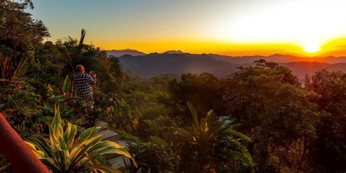 A tourist photographs the sunrise at Finca Don Gabriel, Pluma Hidalgo, Pochutla, Oxaca state,