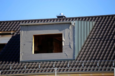 Roofer working on a new dormer window