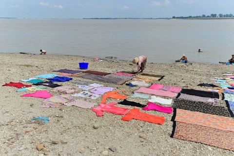 Washing clothes in the Irrawaddy, Myanmar, Asia