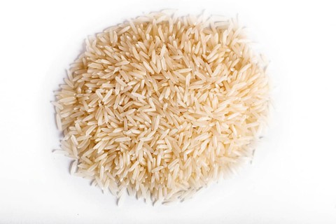 Pile of basmati rice isolated on white background. Top view
