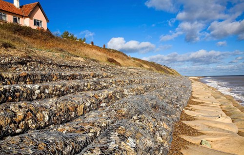 Coastal defences normally covered by shingle exposed by winter storms at Thorpeness, Suffolk,