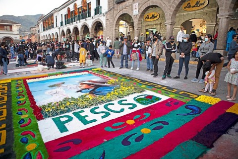 Peruvian people look at a floor painting in the Plaza de Armas, Ayacucho, Huamanga province, Peru,