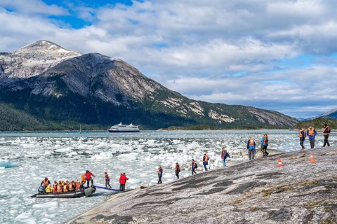 Passengers of the cruise ship Stella Australis board an inflatable boat between ice floes at Pia