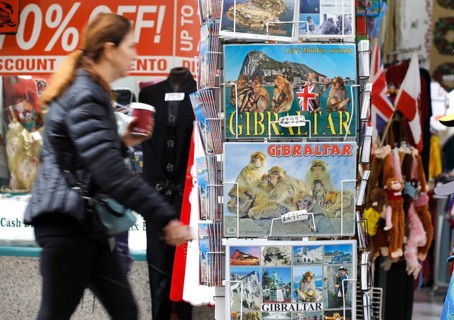 A shop in Gibraltar offers postcards with Gibraltar motifs.thousands of Spaniards commute from