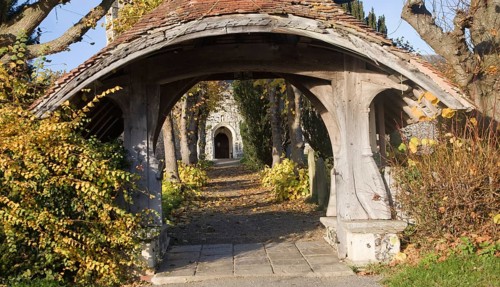 Historic wooden lychgate entrance to St Mary church, Kelsale, Suffolk England