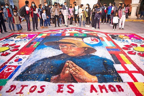 Peruvian people look at a floor painting in the Plaza de Armas, Ayacucho, Huamanga province, Peru,
