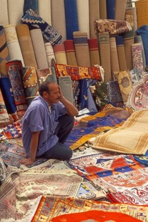 Resting carpet seller at market in Torre del Mar, Andalusia, Spain, Southern Europe. Scanned