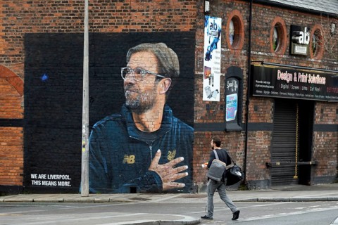 A large poster with a picture of Juegen Klopp, the coach of Liverpool FC, and the slogan We are