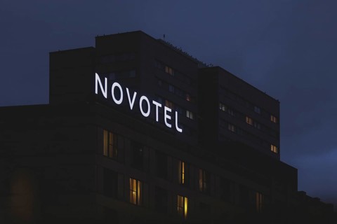 The Novotel hotel chain sign stands out in front of a block of flats in Berlin, 20/02/2024