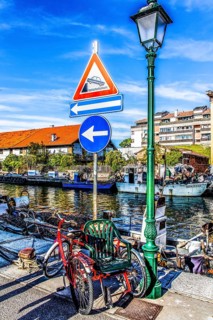 Self-built wheelchair, in the harbour, island of the lagoon town of Grado, northern Adriatic coast,
