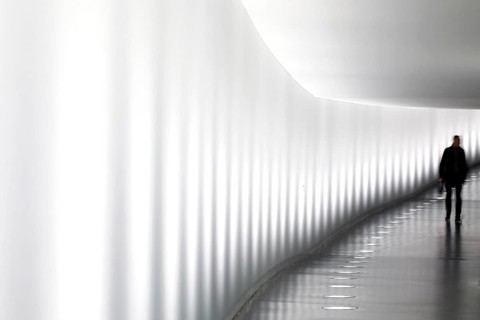 Members of the German Bundestag walk through a tunnel. The tunnel connects the Reichstag and the