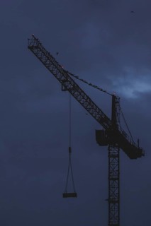 A crane works at blue hour in Berlin, 20/02/2024