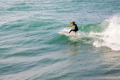 Young man wearing wet-suit surfing in Cornwall, England, United Kingdom, Europe