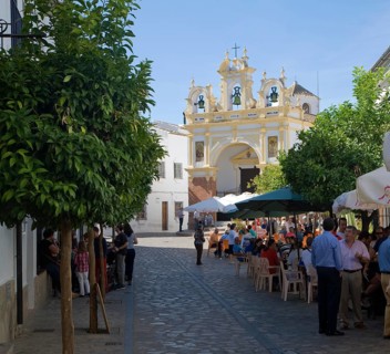 People gather in cafes and by the baroque church of San Juan at Zahara de la Sierra, Spain Sunday
