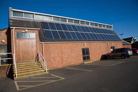 Rooftop array solar panels on community centre building, Woodbridge, Suffolk, England, United