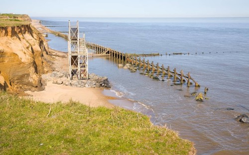 Former beach access stairs and old sea defences at Happisburgh, Norfolk, England, United Kingdom,
