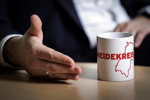 Lars Klingbeil, SPD party leader, gestures next to a cup labelled Heidekreis during an interview in