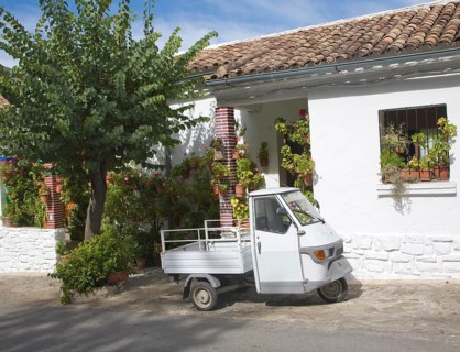 Small three wheeled truck vehicle outside village house Grazalema, Spain, Europe