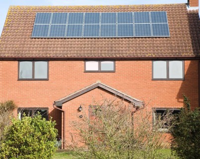 Photovoltaic solar panels on roof of modern suburban house, Martlesham, Suffolk, England, United