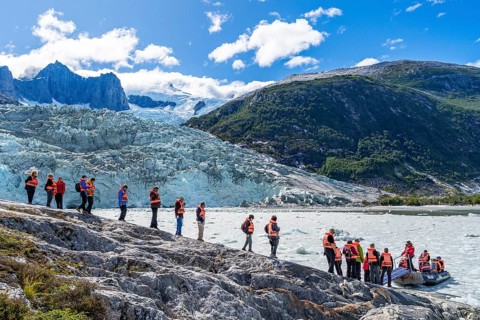 Passengers of the cruise ship Stella Australis board an inflatable boat between ice floes at Pia