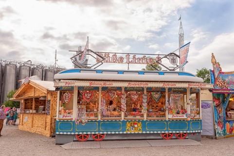 Folk festival and funfair stand, shape of Bavarian tram, almonds, sweets, children, moated castle
