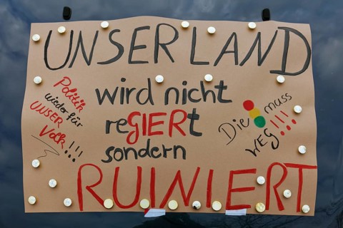 Sign criticising the government on a car, farmers' protests, demonstration against policies of the