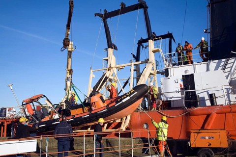 Men loading offshore supply vessel Putford Achilles, Great Yarmouth