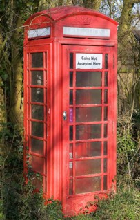 'Coins Not Accepted Here' sign on rural red telephone box, Suffolk, England, United Kingdom, Europe