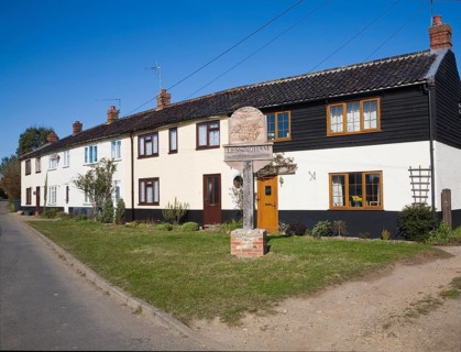 Cottages and village sign at Lessingham, Norfolk, England, United Kingdom, Europe