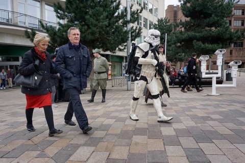 People walk past carnies in Star Wars costumes on a shopping street in Liverpool, 02/03/2019