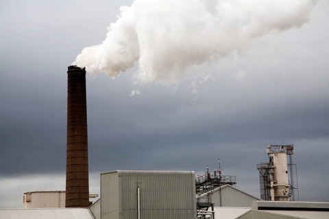 Steam rising from chimneys as sugar beet is processed at the British Sugar factory, Bury St