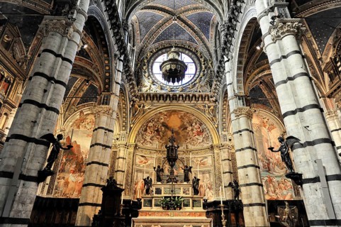 Black and white striped marble columns in the cathedral, cross and round arches, Siena, Tuscany,