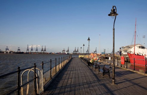 Person enjoying afternoon sunshine Ha'penny pier Harwich, Essex, England, United Kingdom, Europe