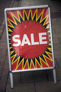 Close up of street shop Sale poster standing on pavement