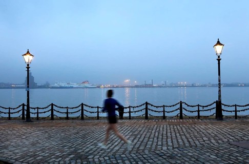 A woman jogs in the morning near the Royal Albert Dock in Liverpool, 01/03/2019