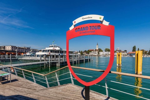 Excursion boat St. Gallen and advertising sign Grand Tour of Switzerland in the harbour,