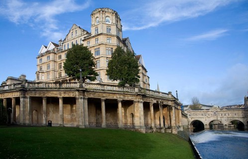 The former Empire Hotel, River Avon and Pulteney Bridge from Parade Gardens, Bath, Somerset,