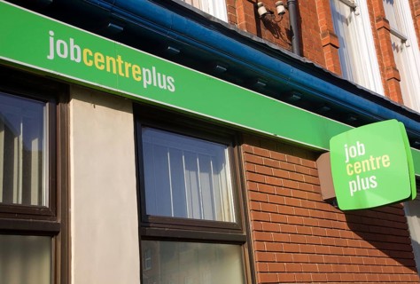 Close up of Job Centre Plus green signs on wall, England, UK