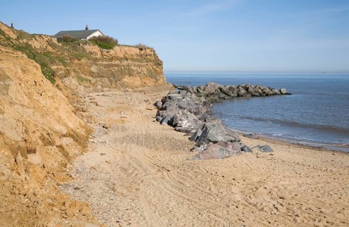 Rock armour used to defend soft crumbling cliffs, Happisburgh, Norfolk, England, United Kingdom,