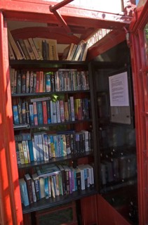 Old red telephone box used for book exchange, Suffolk, England, United Kingdom, Europe