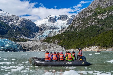 Passengers of the cruise ship Stella Australis in rubber dinghies in front of the ice of the Porter