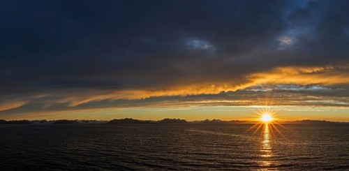 Sun setting on a rainy evening over Isfjorden, Isfjord in summer at sunset, Spitsbergen, Svalbard,