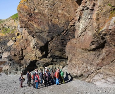 Student group of geologists on a fieldtrip at Polpeor Cove, Lizard Point, Cornwall, England, United