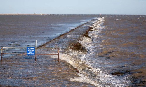 High seas forcing waves over the harbour mouth breakwater at Harwich, Essex, England, United